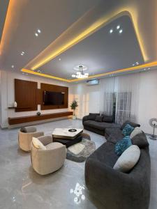 a large living room with couches and a flat screen tv at Modern and luxurious villa, comfort and tranquility in Saly Portudal +30 photos