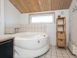 baño con bañera blanca y ventana en Luxury Retreat near Beach - By Traum Ferienwohnungen, en Fanø