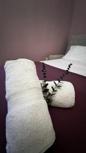 a bed with a white blanket and a plant on it at De Rohan Central Townhouse 38 in Taʼ l-Infetti +23 photos