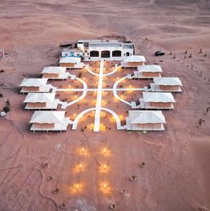 an aerial view of tents in a desert at night at iMei Lux Camp 爱梅野奢营地 in Lac Yasmins