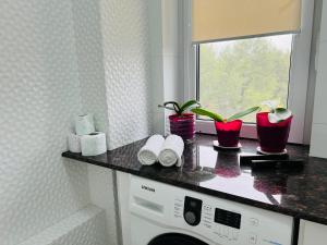 a washing machine in a bathroom with a window at Apartament new in Chişinău +65 photos