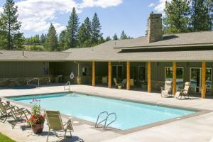 a swimming pool in front of a house at Beautiful Bend Retreat - Meredith Lodging in Bend