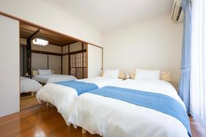 Ένα ή περισσότερα κρεβάτια σε δωμάτιο στο Shiokaze