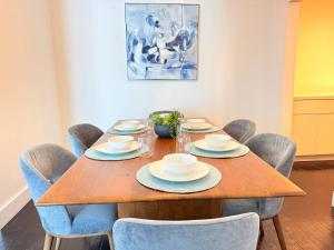 a dining room with a wooden table and chairs at Beachfront 2BR at The Tides | EPIC Stay in Hollywood