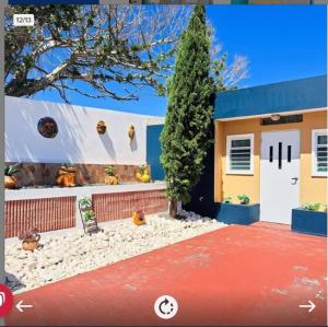 a house with a lot of figurines in front of it at Cozy Apartment, Isabela in Galateo Bajo