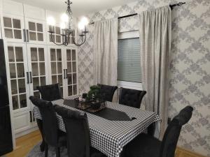 a dining room with a table and black chairs at Luxury Heaven Vogošća in Vogošća