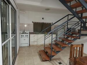 a kitchen with a spiral staircase in a house at Refugio del Este in San Martín