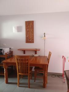 a dining room table with two chairs and a wooden table at VIP condochain 24th floor in Ban Phe +2 photos