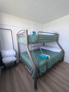 a bunk bed room with two bunk beds and a chair at Marina Views & Island Adventures: Fajardo Condo with Pool in Beltran +16 photos