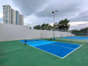 two tennis courts on a tennis court at Marina Views & Island Adventures: Fajardo Condo with Pool in Beltran