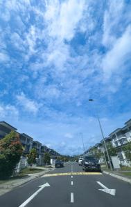 New Homestay Sandakan Rimbayu 12pax في سانداكان: شارع فيه سيارات تقف على جانب الطريق