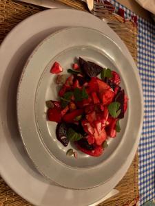 a plate of food with strawberries on a table at Merzouga Sizar Luxury Camp in Merzouga