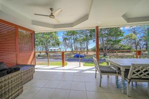 a screened in porch with a table and chairs at 24 The Esplanade in Woodgate