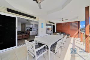 a dining room with a table and chairs at 24 The Esplanade in Woodgate