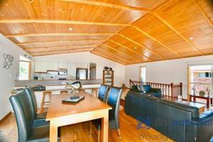 a living room with a table and a dining room at 25 The Esplanade in Woodgate