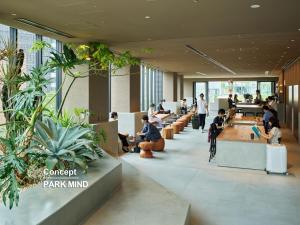 a lobby with people sitting at tables in a cafeteria at sequence MIYASHITA PARK - Shibuya in Tokyo