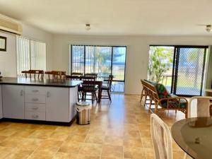 a kitchen and dining room with a table and chairs at 71 The Esplanade in Woodgate