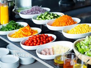 a buffet with bowls of different types of vegetables at sequence MIYASHITA PARK - Shibuya in Tokyo