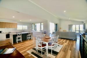 a kitchen and living room with a table and chairs at 158 The Esplanade in Woodgate