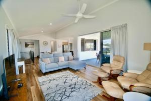 a living room with a couch and a ceiling fan at 158 The Esplanade in Woodgate