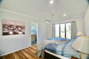 a bedroom with a bed and a painting on the wall at 158 The Esplanade in Woodgate