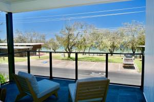 a room with a view of a street from a window at 158 The Esplanade in Woodgate
