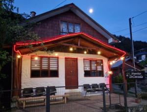 a house with christmas lights in front of it at La cascada in Futaleufú