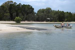 two men in a boat in the water at 100 The Esplanade in Woodgate