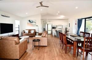 a living room with a couch and a table at 62 First Avenue in Woodgate