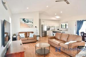 a living room with a couch and a table at 62 First Avenue in Woodgate