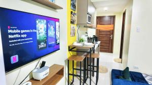 a living room with a flat screen tv on a wall at Horizons 101 in Cebu City