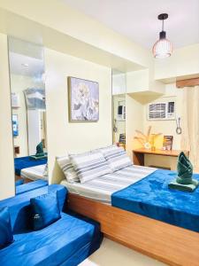 a bedroom with two beds and a mirror at Horizons 101 in Cebu City