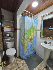 a bathroom with a toilet and a map shower curtain at Hostal Sol y Luna - a 10 min del aeropuerto & Desayuno Incluido in Santiago +52 photos