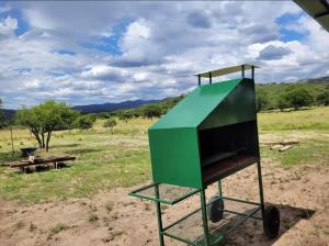 a green object with a picnic table in a field at Cabaña Elun in Panaholma
