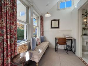 a living room with a couch and a table and a window at Arrowtown Lodge in Arrowtown