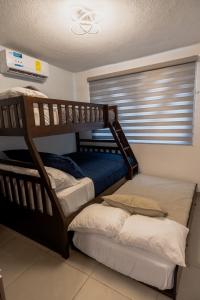 Кровать или кровати в номере Beachfront house in Acapulco beach club