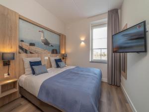 a bedroom with a bed with a bird on the wall at SeaLuxe Suite 27D in Colijnsplaat
