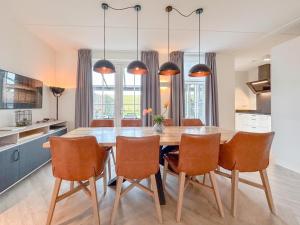 a kitchen with a dining room table and chairs at Happy Beach 48 in Colijnsplaat
