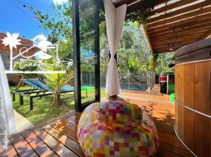 a large ball sitting on a deck near a window at Nano Resort in Porangaba