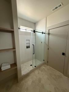 a bathroom with a shower and a glass shower door at Moses Lake Vineyard Retreat-Waterfront Escapism in Moses Lake