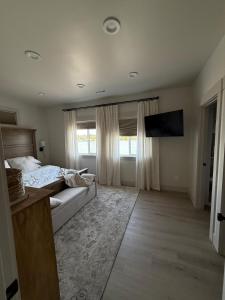a bedroom with a bed and a large window at Moses Lake Vineyard Retreat-Waterfront Escapism in Moses Lake