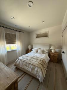 a bedroom with a large bed with two night stands and a window at Moses Lake Vineyard Retreat-Waterfront Escapism in Moses Lake +65 photos