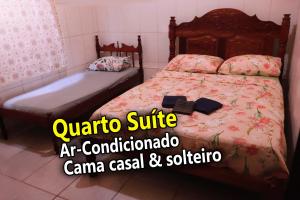 a bedroom with a bed with avertisement for at Casa Ybirá de Alter do Chão in Alter do Chao