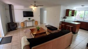a living room with a couch and a table at Peaceful Country Home Between Brisbane & GC in Wolfdene