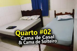 two twin beds in a room with a sign that says quatoro at Casa Ybirá de Alter do Chão in Alter do Chao +30 photos