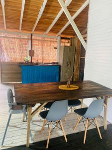 a wooden table on a patio with two chairs at Una Habitación baño privado Casa Mango in Zapzurro