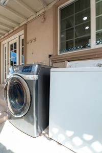 a washing machine sitting in front of a house at Near Safari & Beach - Backyard Games - AC - Pet OK in Escondido