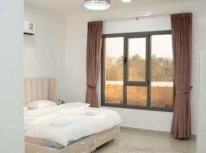 Ένα ή περισσότερα κρεβάτια σε δωμάτιο στο استراحة روضة الوادي - Rawdat Al Wadi House