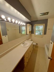 a bathroom with a sink and a mirror at Location! Large Home, Country Views, Entertainment in Dubuque