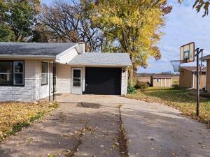 a small white house with a basketball hoop at Location! Large Home, Country Views, Entertainment in Dubuque